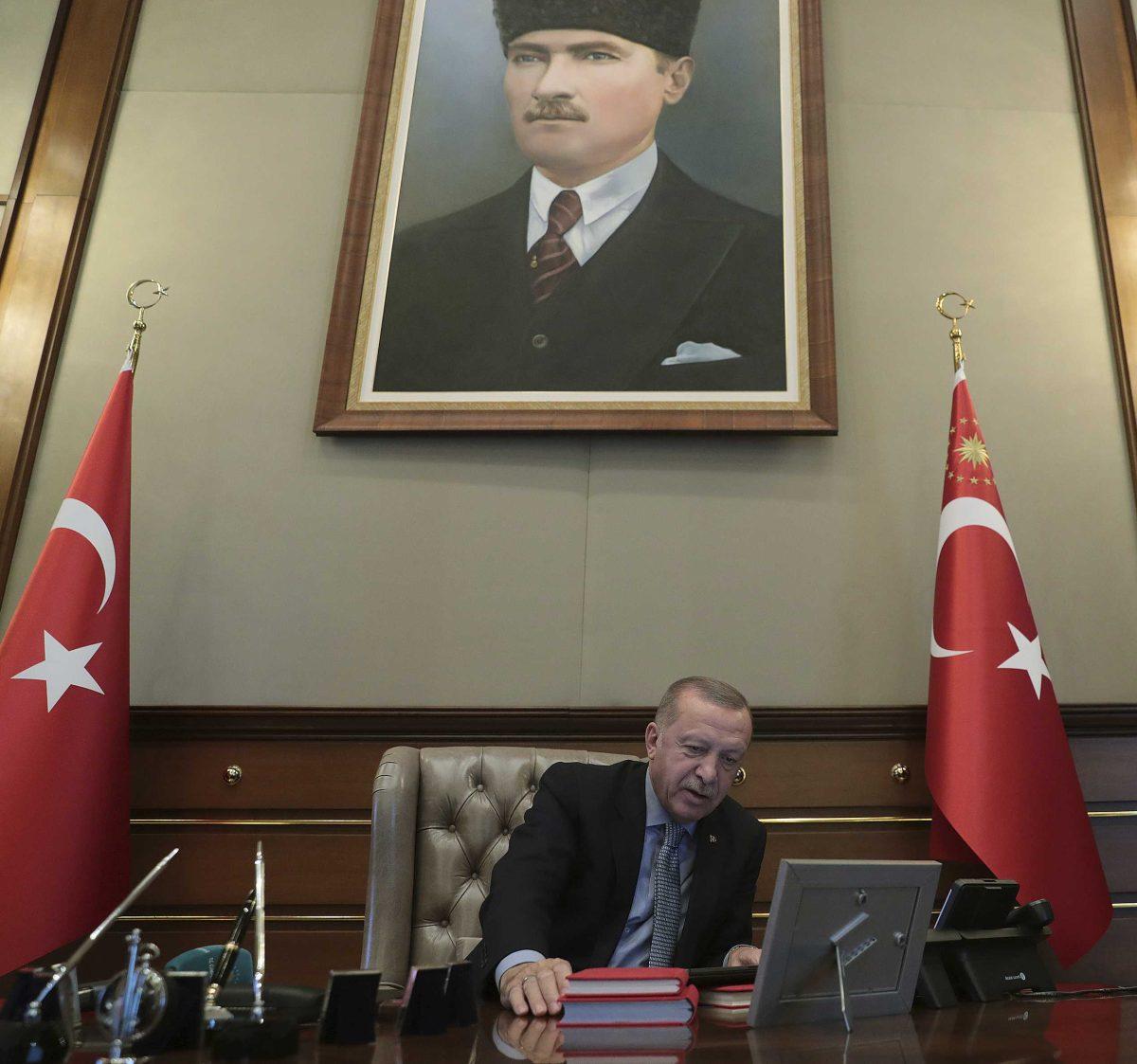 Turkey's President Recep Tayyip Erdogan speaks on the phone with Defense Minister Hulusi Akar before reportedly giving orders for the start of the military operation into Syria, in Ankara, Turkey, Wednesday, Oct. 9, 2019. Minutes before Erdogan's announcement, Turkish jets began pounding suspected Syrian Kurdish positions in the Syrian town of Ras al Ayn, according to Turkish media reports.(Turkish Presidency Press Service via AP, Pool)