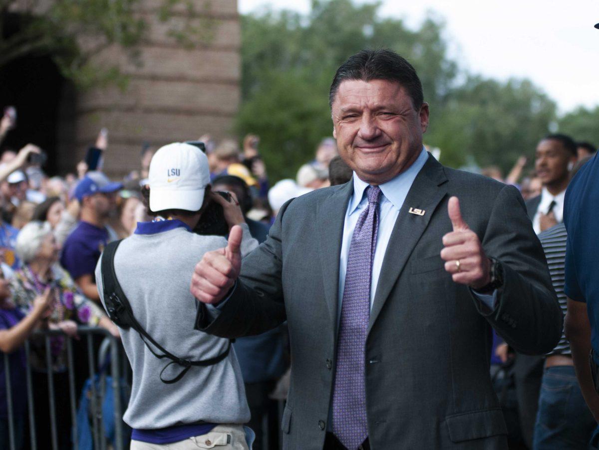 LSU Coach Ed Orgeron greets fans the march down Victory Hill on Saturday, Oct. 12, 2019.