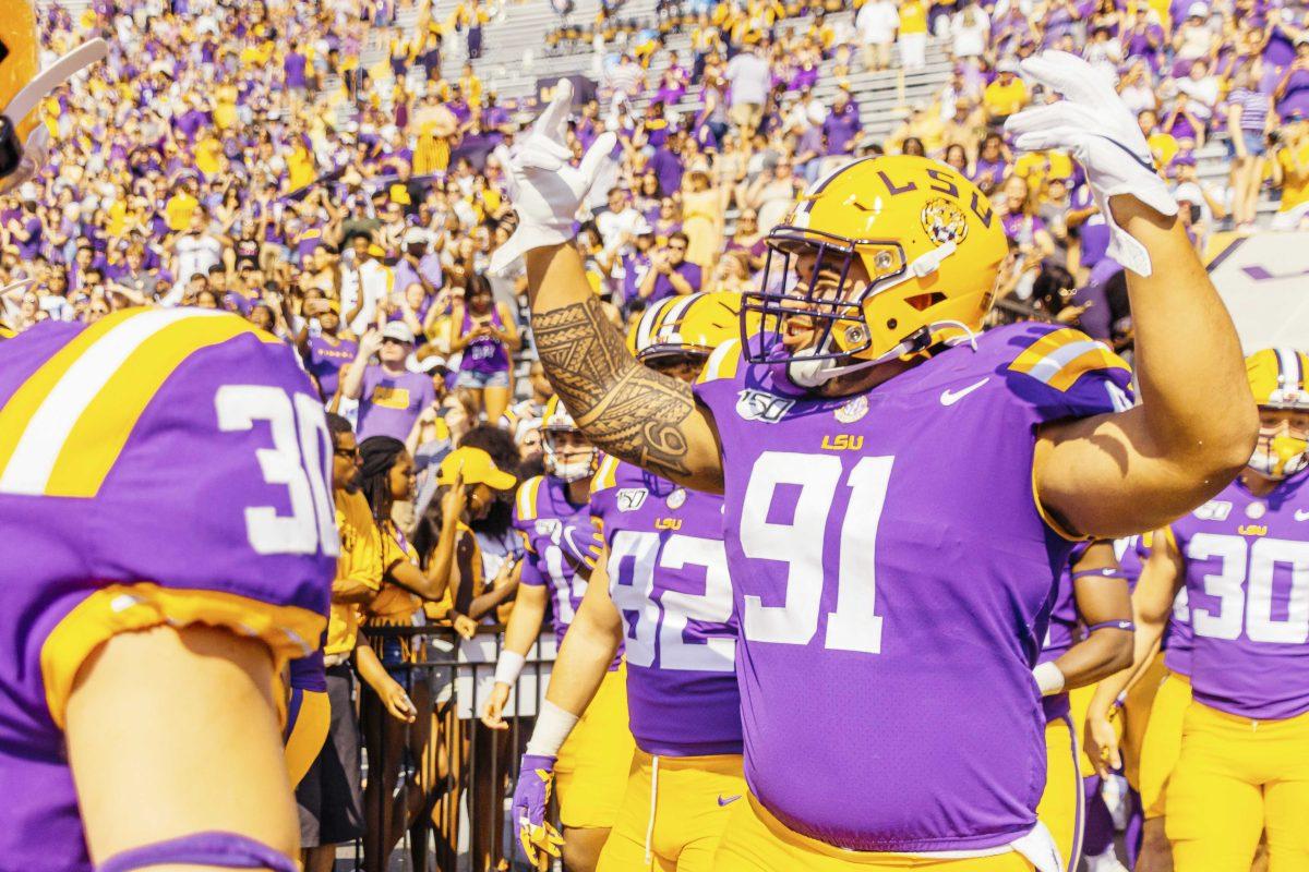 LSU senior defensive line Breiden Fehoko (91) gets cheered on coming into Tiger Stadium before the Tigers' 42-6 win against Utah State on Saturday, October 5, 2019.