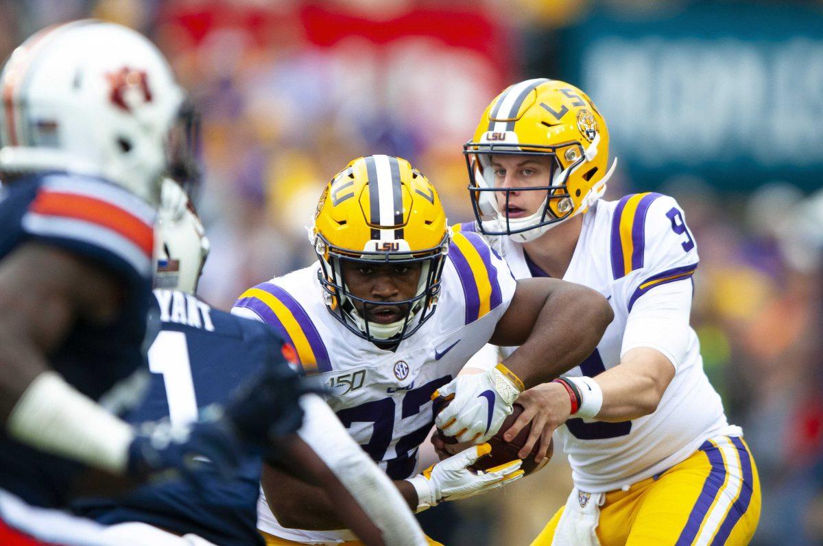 LSU senior quarterback Joe Burrow (9) hands the ball off to LSU junior running back Clyde Edwards-Helaire (22) during the Tigers&#8217; 23-20 victory over Auburn on Saturday, Oct. 26, 2019, in Tiger Stadium.