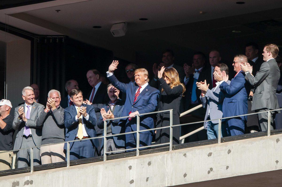 President Donald Trump waves to fans during the Tigers' 46-41 victory over Alabama in Bryant-Denny Stadium on Saturday, Nov. 9, 2019.