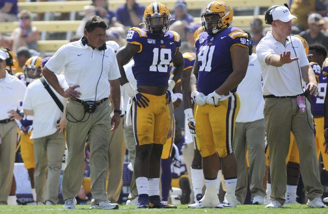 LSU football coach Ed Orgeron and his players stand on the sideline during the Tigers' 46-6 victory over Utah State on Saturday, Oct. 5, 2019, at Tiger Stadium.