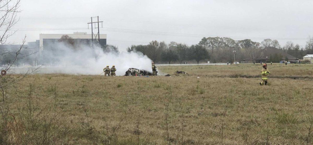 This photo provided by AcadianNews shows first responders looking over the site of a plane crash near Feu Follet Road and Verot School Road in Lafayette, La., Saturday, Dec. 28, 2019. Authorities confirmed the accident but details on whether anyone was injured was not immediately known. (AcadianNews via AP)