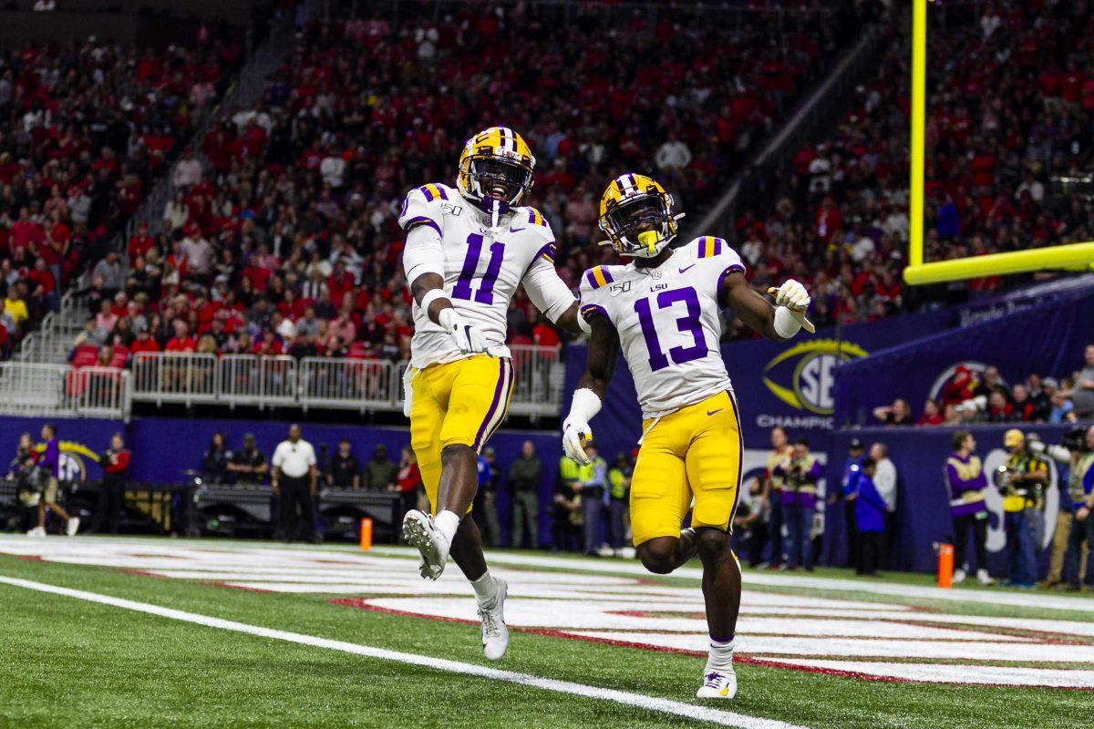 LSU football players celebrate in the end zone during the Tigers' 37-10 victory over Georgia on Saturday, Dec. 7, 2019, in Mercedes Benz Stadium.