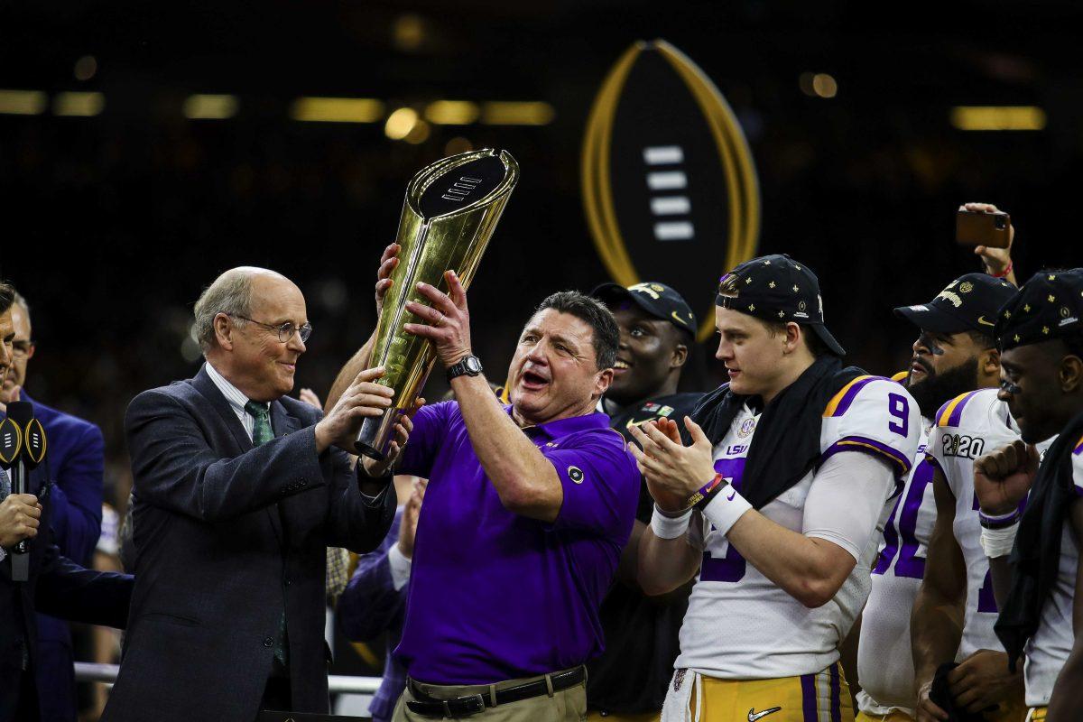 LSU football coach Ed Ogeron accepts the national championship trophy after the Tigers 45-25 victory over Clemson in the Mercedes Benz Super Dome, on Monday, Jan. 13, 2020.