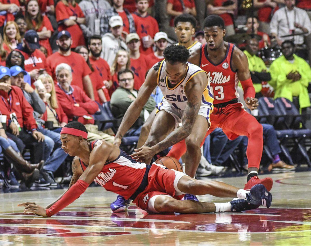 Mississippi guard Austin Crowley (1), LSU guard Javonte Smart (1) and Mississippi guard Bryce Williams (13) go for the ball during an NCAA college basketball game in Oxford, Miss., Saturday, Jan. 18, 2020. (Bruce Newman/The Oxford Eagle via AP)