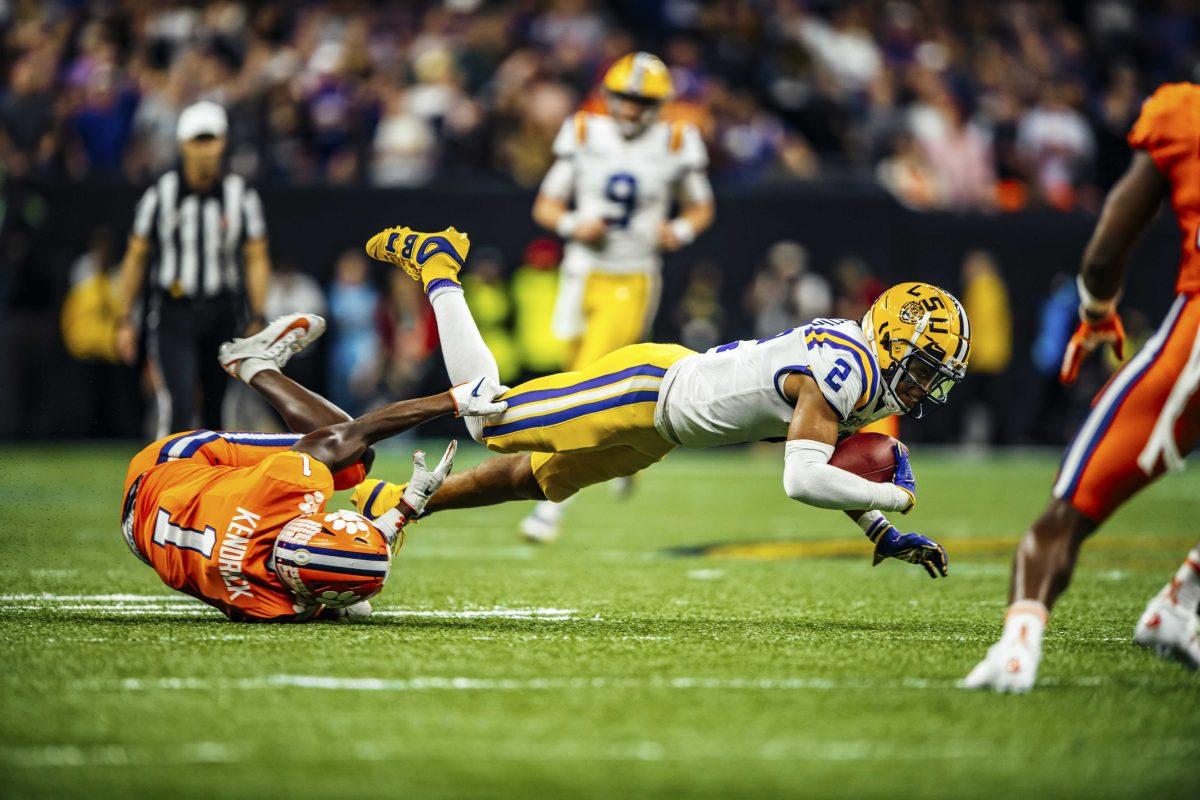 LSU junior wide receiver Justin Jefferson (2) gets brought down by an opposing player on Monday, January 13, 2020 during LSU's 42-25 win against Clemson at the National Championship at the Mercedes-Benz Superdome.