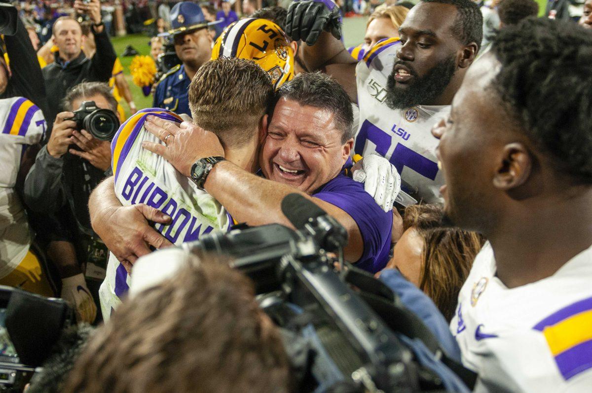 LSU senior quarterback Joe Burrow (9) and football coach Ed Orgeron celebrate after the Tigers' 46-41 victory over Alabama in Bryant-Denny Stadium on Saturday, Nov. 9, 2019.