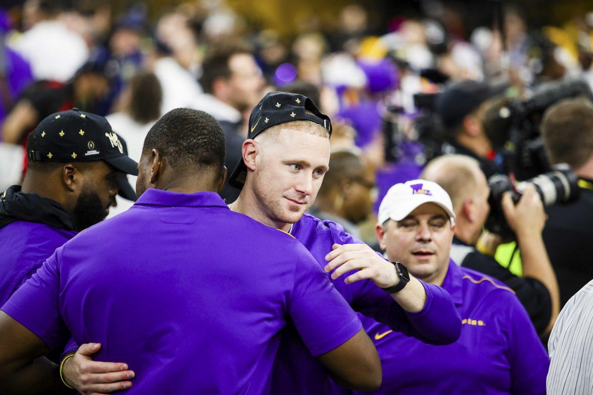 LSU passing game coordinator Joe Brady hugs his colleagues after the Tigers 45-25 victory over Clemson in the Mercedes Benz Super Dome, on Monday, Jan. 13, 2020.