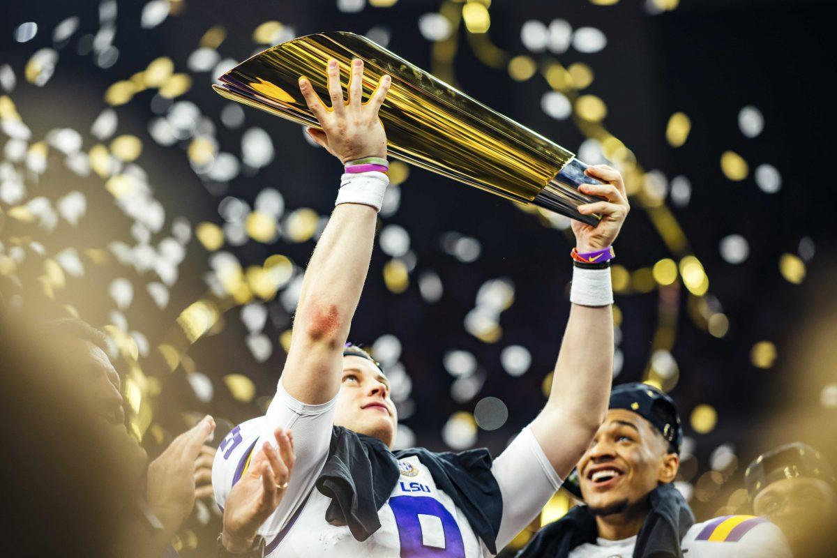 LSU senior quarterback Joe Burrow (9) holds up the trophy on Monday, January 13, 2020 after LSU's 42-25 win against Clemson at the National Championship in the Mercedes-Benz Superdome.