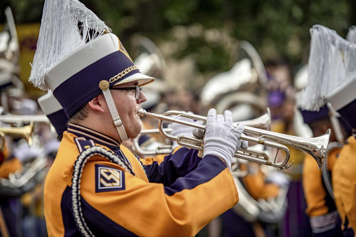 A member of the LSU Tiger Band walks down Field House Drive during the National Championship Parade on Saturday, Jan. 18, 2020.