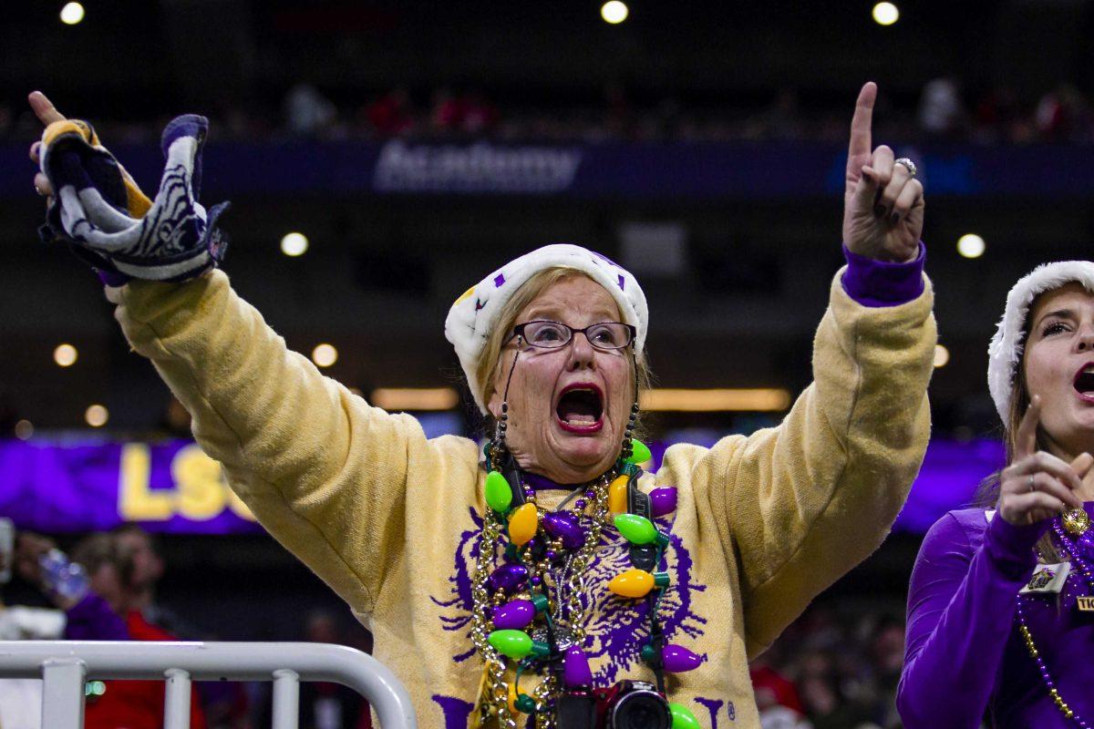 An LSU fan cheers during the Tigers' 37-10 victory over Georgia on Saturday, Dec. 7, 2019, in Mercedes Benz Stadium.