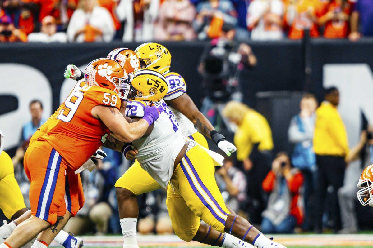 LSU sophomore nose tackle Tyler Shelvin tackles an opposing player on the field on Monday, January 13, 2020 during LSU's 42-25 win against Clemson in the Mercedes-Benz Superdome.