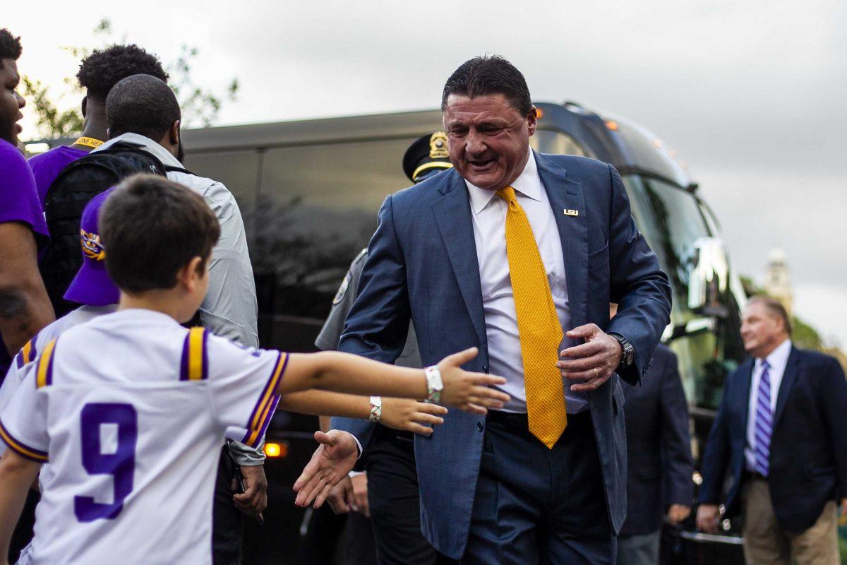 LSU football coach Ed Orgeron high fives fans at Victory Hill on Saturday, Nov. 30, 2019.