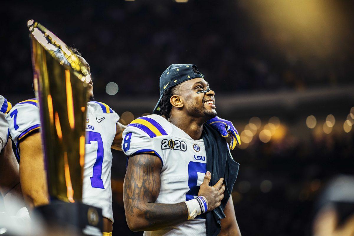 LSU junior linebacker Patrick Queen (8) smiles at the crowd on Monday, January 13, 2020 after LSU's 42-25 win at the National Championship in the Mercedes-Benz Superdome.