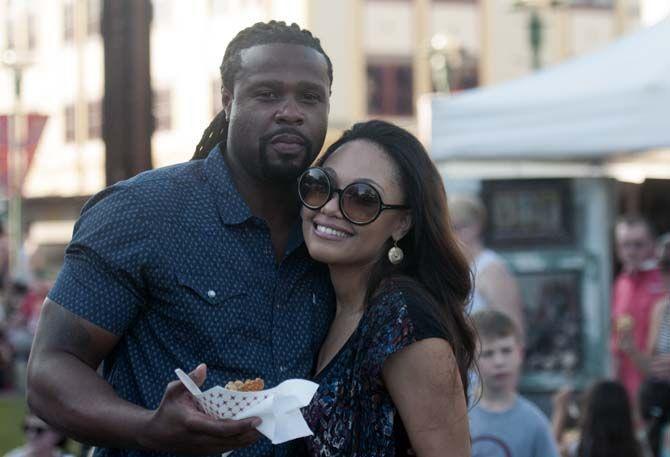 A couple poses for a photograph while eating crawfish etouffee on Saturday, April 25, 2015 during Festival International de Louisiane in Lafayette.