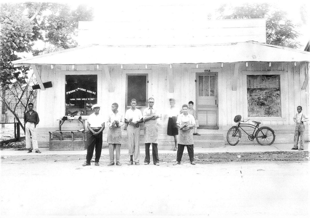 Frank Morris standing outside of his shoe shop.