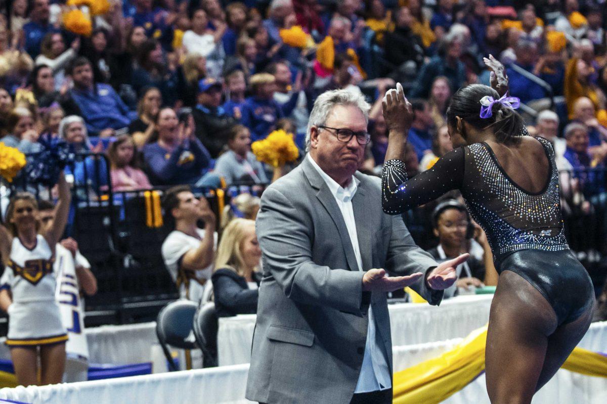 LSU Assistant Coach Bob Moore cheers on gymnastics freshman Kiya Johnson on Friday, January 2020 during LSU's 196.775 to 196.425 loss to Alabama in the PMAC.