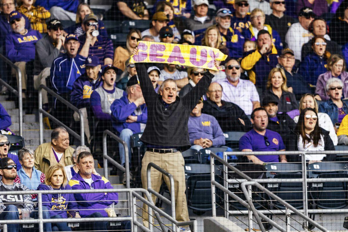 An LSU fan gets the crowd going with cheers during LSU's 7-4 victory against Indiana in Game 2 on Saturday, Feb. 15, 2020 in Alex Box.