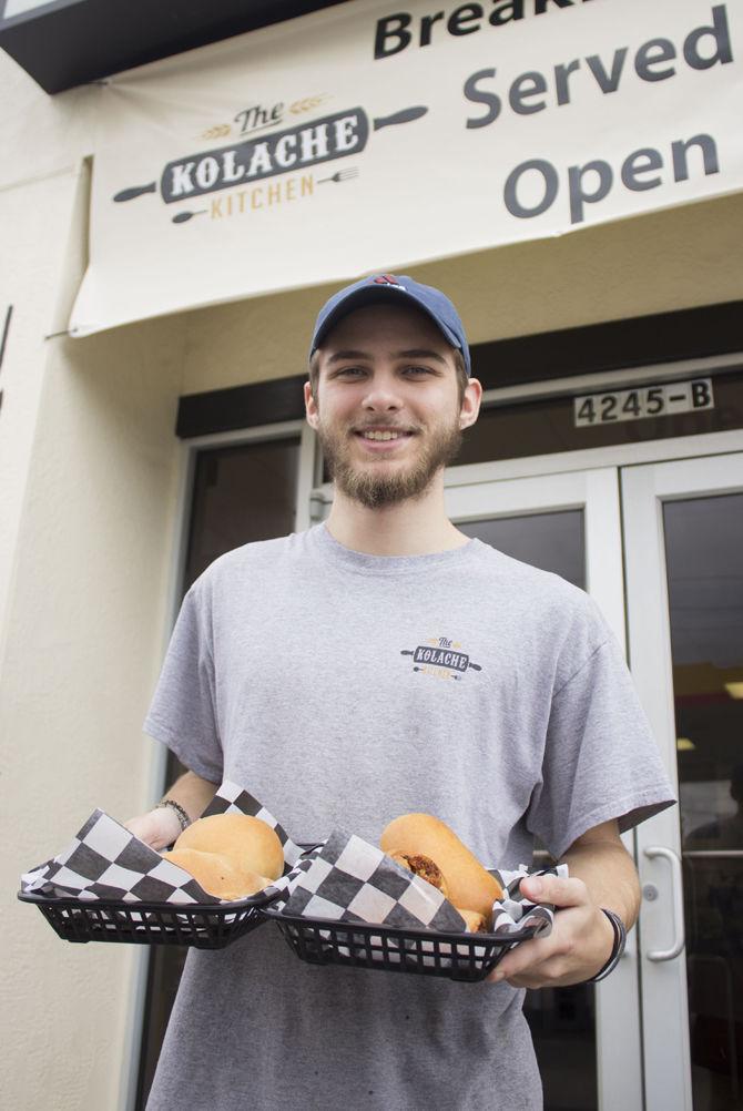 Employee Billy Patterson displays kolaches in front of The Kolache Kitchen on Feb. 12, 2017.