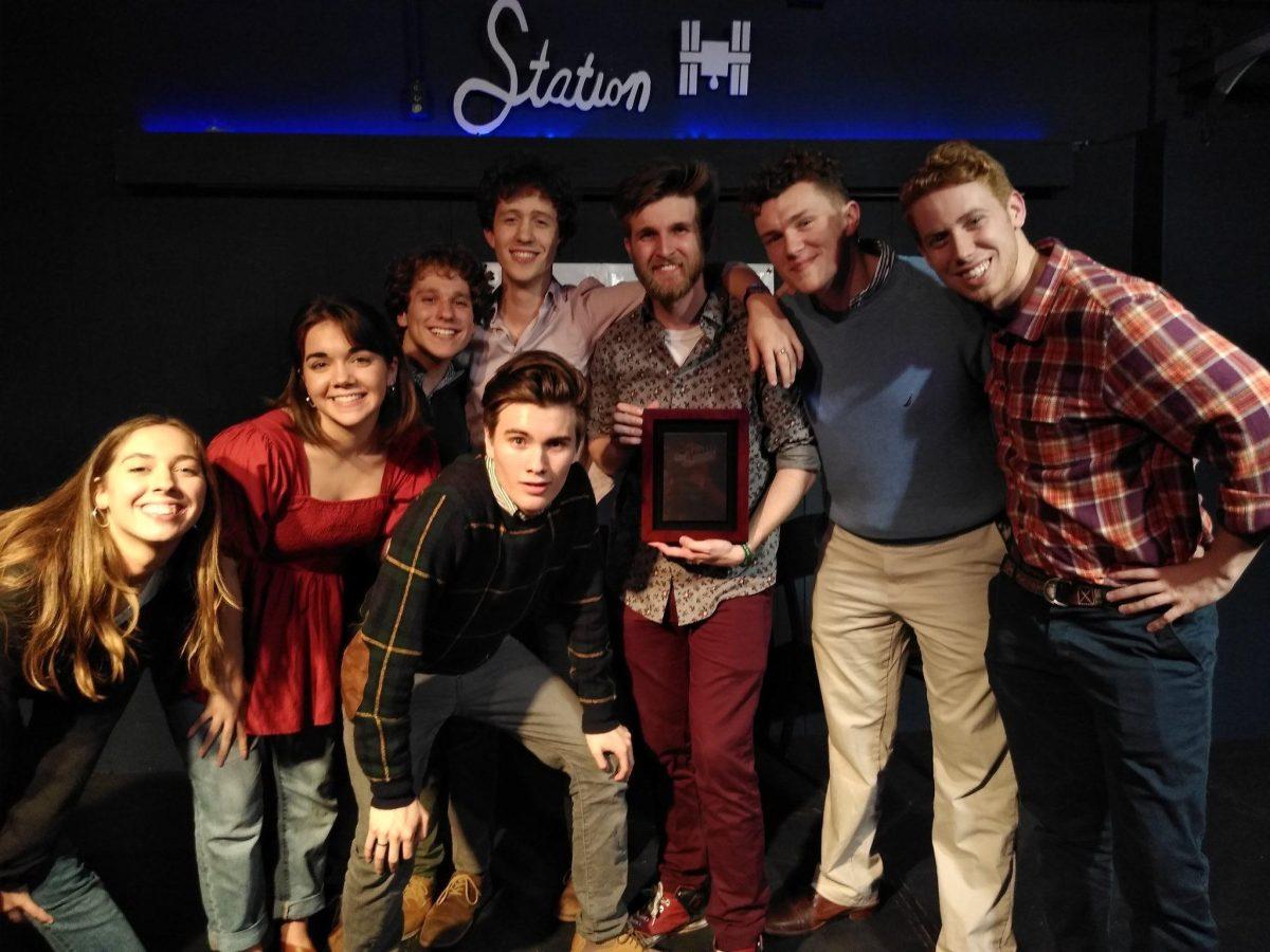 ImprovLSU team members smile with their trophy after winning the College Improv Tournament's Southwest Championship in Houston.