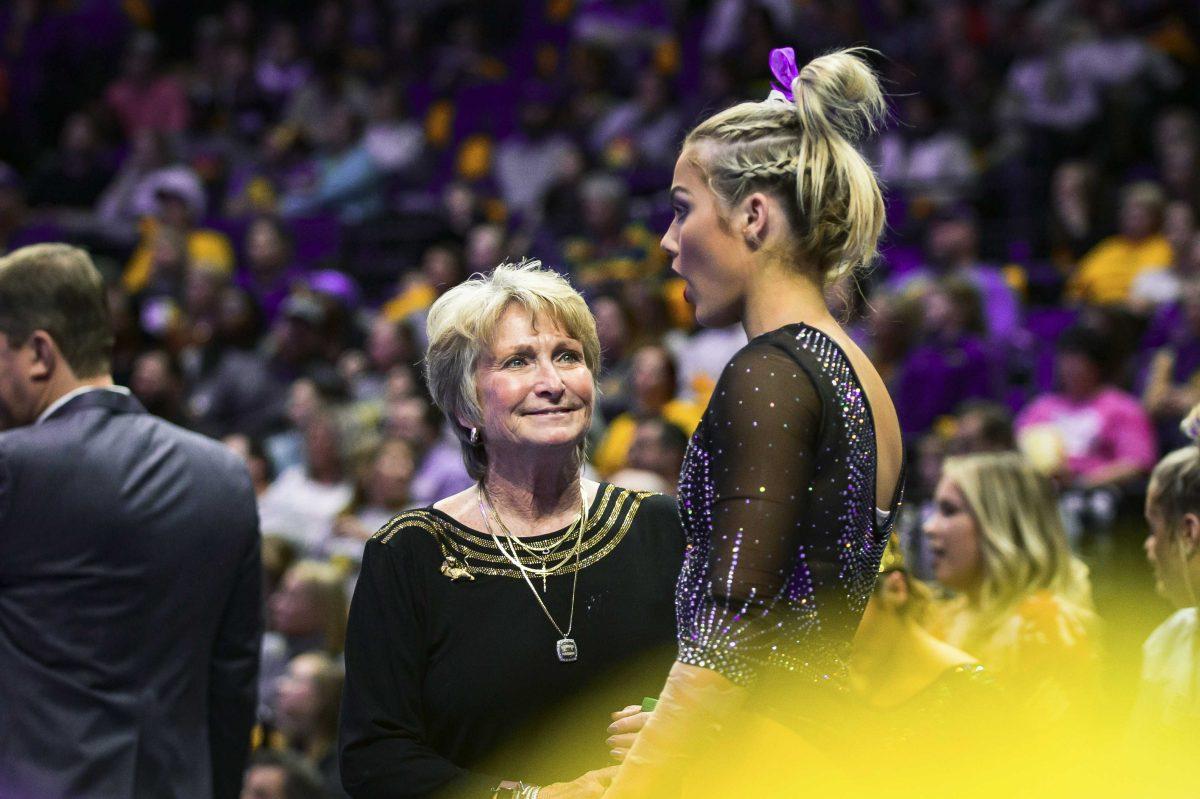 LSU Co-Head Coach D-D Breaux smiles at gymnastics junior Bridget Dean before her beam routine on Friday, January 2020 during LSU's 196.775 to 196.425 loss to Alabama in the PMAC.