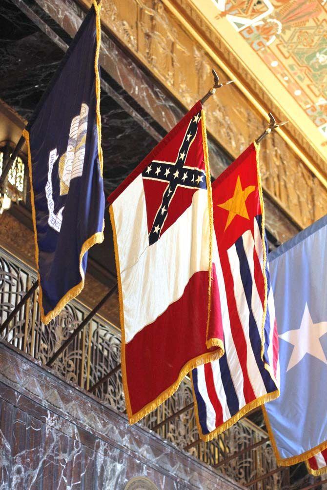 The confederate flag, among other flags, hangs above the elevators on Saturday, Aug. 22, 2015, in the Louisiana State Capitol.