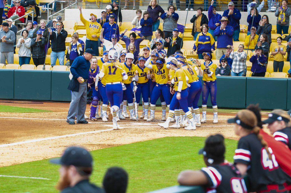 LSU softball players celebrate first home run of game on Sunday, Feb. 16, 2020 during the Tiger's 4-3 win against University of Louisiana Lafayette in Tiger Park.