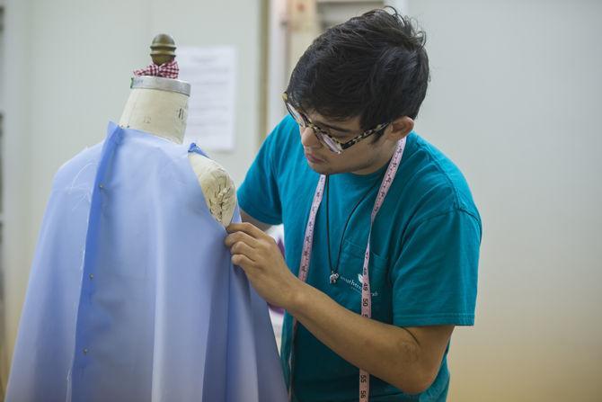 LSU textiles, apparel, and merchandizing senior Oscar Hernandez prepares garments for LSU Fashion Association's upcoming fashion show.