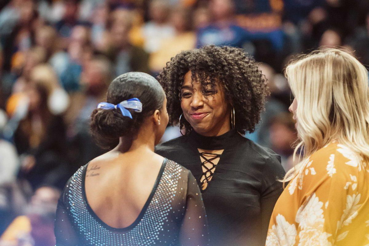 LSU gymnastics Volunteer Coach Ashleigh Clare-Kearney smiles at senior Kennedi Edney before her beam routine on Friday, January 2020 during LSU's 196.775 to 196.425 loss to Alabama in the PMAC.