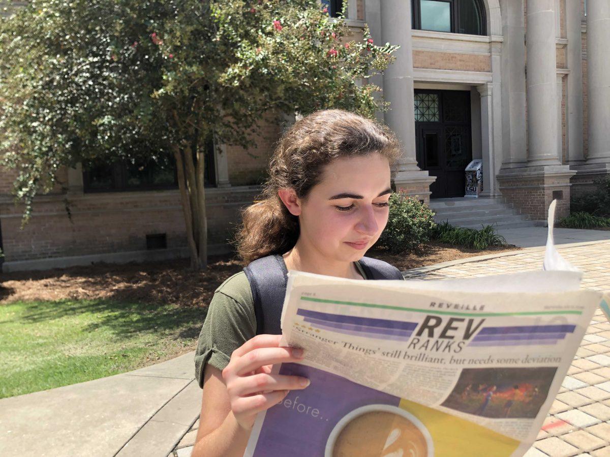 Freshman Madalyn Mouton reads a copy of the Reveille on Thursday, August 22, 2019.