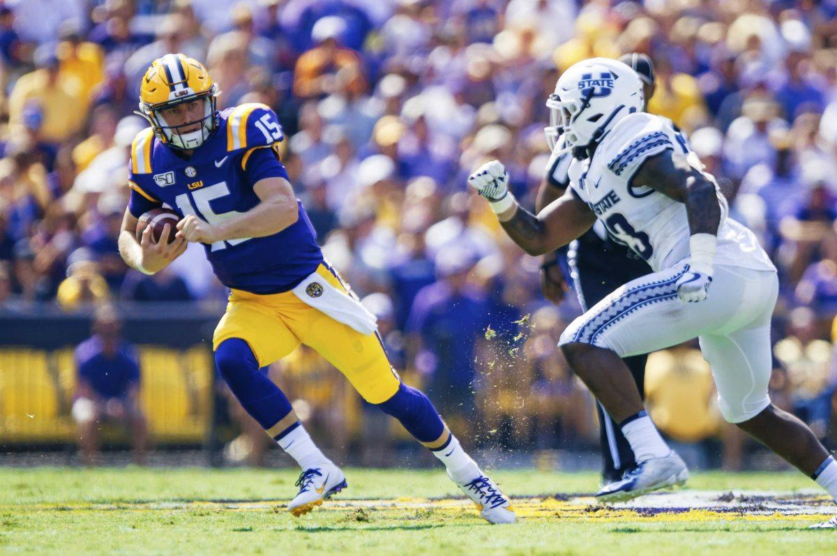 LSU sophomore quarterback Myles Brennan (15) runs with the ball during the Tiger's 42-6 win against Utah State on Saturday, October 5, 2019 at Tiger Stadium.