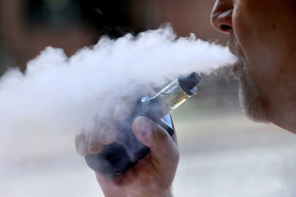 In this Aug. 28, 2019, file photo, a man exhales while smoking an e-cigarette in Portland, Maine. (AP Photo/Robert F. Bukaty, File)