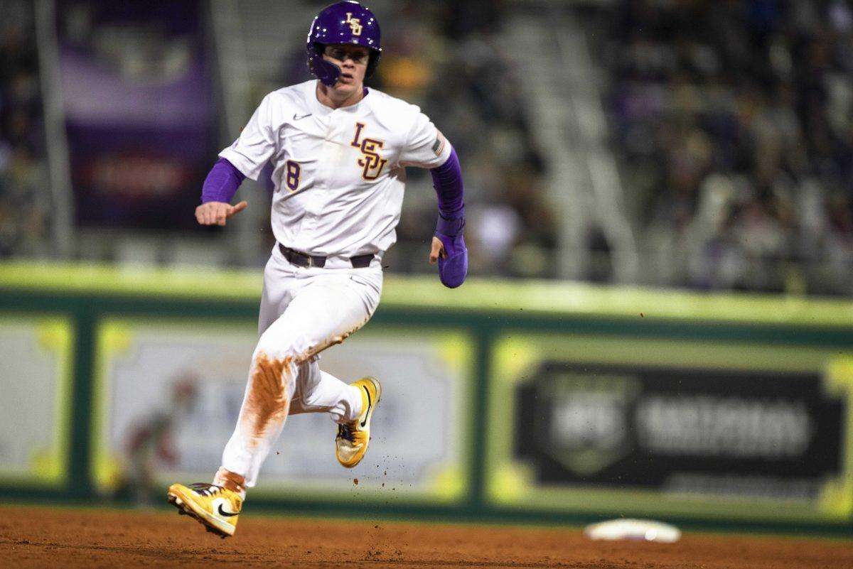 LSU baseball junior outfielder Daniel Cabrera (8) sprints toward third base during LSU baseball&#8217;s season opening 8-1 win against Indiana in Alex Box Stadium on Feb. 14, 2020.