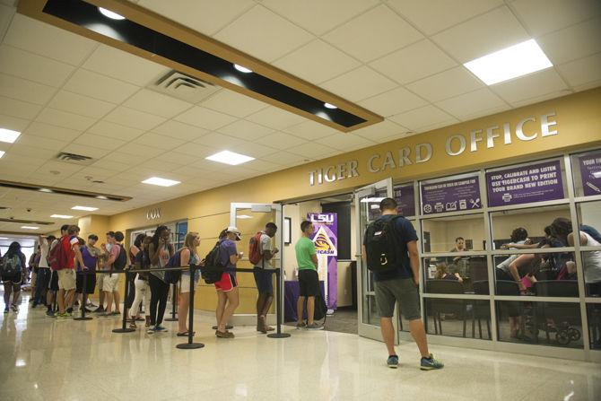 LSU students wait outside Auxiliary Services in the Student Union, Monday, Aug. 24 after several students said their Tiger Cards are not working for meal plans, Paw Point or to get in and out of residence halls.