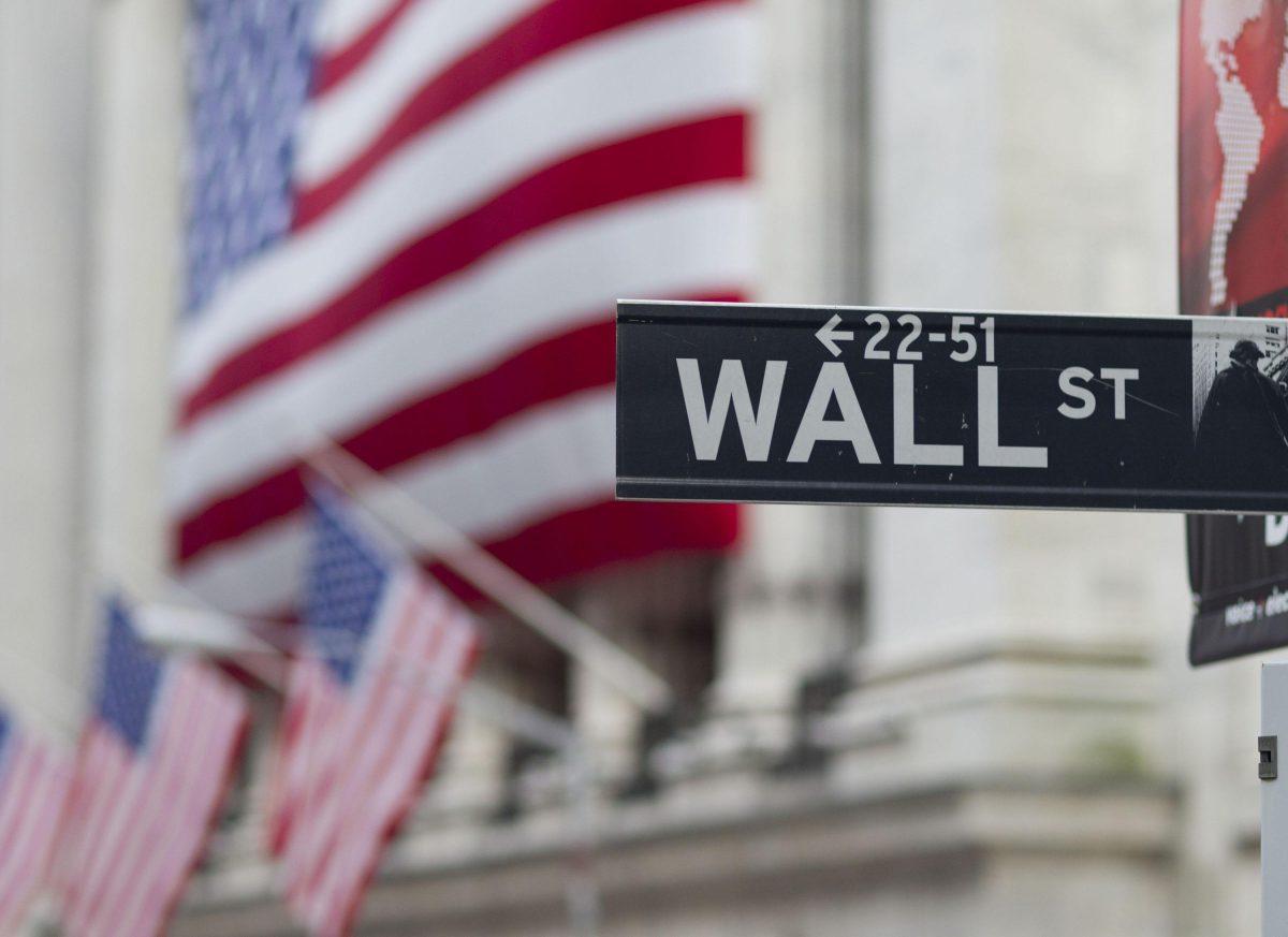 FILE - In this Aug. 8. 2011 file photo, a Wall Street sign hangs near the New York Stock Exchange, in New York. The U.S. stock market is opening modestly higher Monday, March 9, 2015, following a sell-off Friday. (AP Photo/Jin Lee, File)