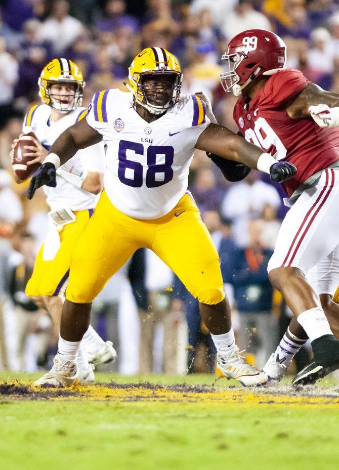 LSU junior guard Damien Lewis (68) blocks for LSU junior quarterback Joe Burrow (9) during the Tigers' 29-0 loss against Alabama on Saturday, Nov. 3, 2018, in Tiger Stadium.