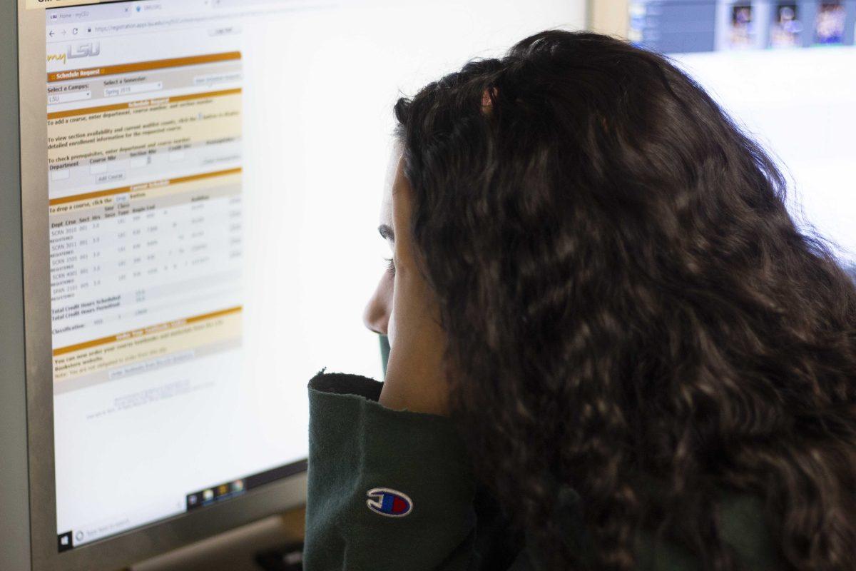 LSU student browses the University's schedule booklet.