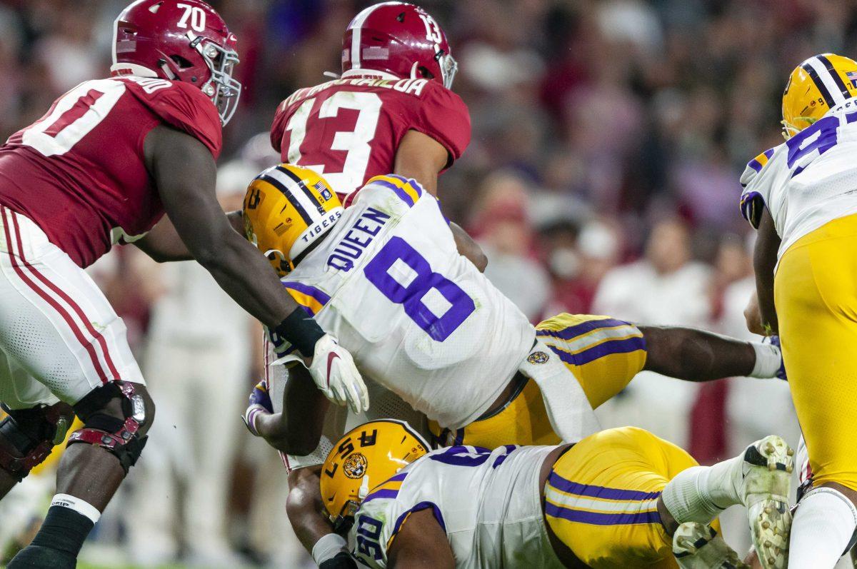 LSU junior linebacker Patrick Queen (8) and senior defensive linemen Rashard Lawrence (90) sack the quarterback during the Tigers' 46-41 victory over Alabama in Bryant-Denny Stadium on Saturday, Nov. 9, 2019.