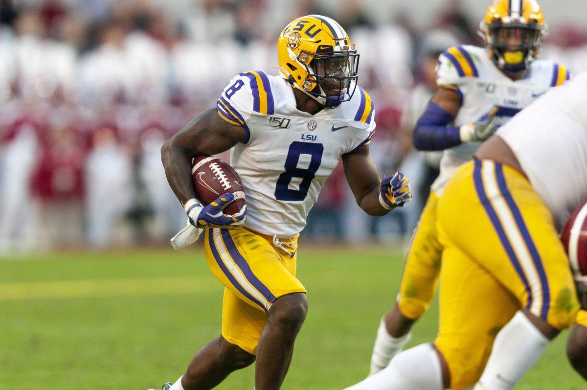 LSU junior linebacker Patrick Queen (8) runs the ball after an interception during the Tigers' 46-41 victory over Alabama in Bryant-Denny Stadium on Saturday, Nov. 9, 2019.