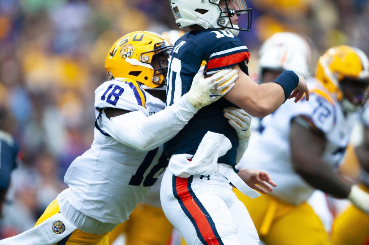 LSU sophomore offensive line backer K&#8217;Lavon Chaisson (18) tackles freshman quarterback Bo Nix (10) during the Tigers&#8217; 23-20 victory over Auburn on Saturday, Oct. 26, 2019, in Tiger Stadium.