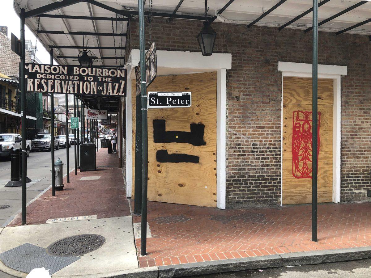 In this May 20, 2020 file photo, a bar is boarded-up at a Bourbon Street intersection in New Orleans' French Quarter. New Orleans will let the good times roll in casinos and bars again beginning Saturday, with restrictions aimed at preventing the spread of COVID-19, Mayor LaToya Cantrell said Tuesday, June 9, 2020. (AP Photo/Kevin McGill, file)