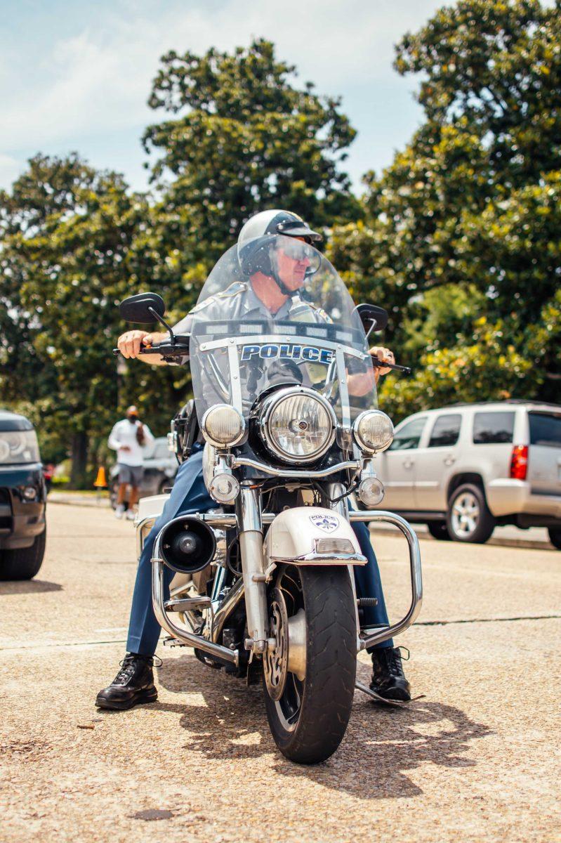 A Baton Rouge police officer watches the crowd of about 1,000 protesters march peacefully to the State Capitol on Sunday, May 31, 2020 during the protest of the death of George Floyd in Downtown Baton Rouge.