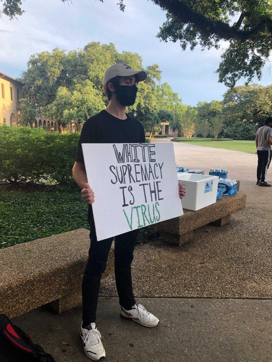 History sophomore Chandler Clegg showed his support by wearing all black and holding a sign which read &#8220;white supremacy is the virus".