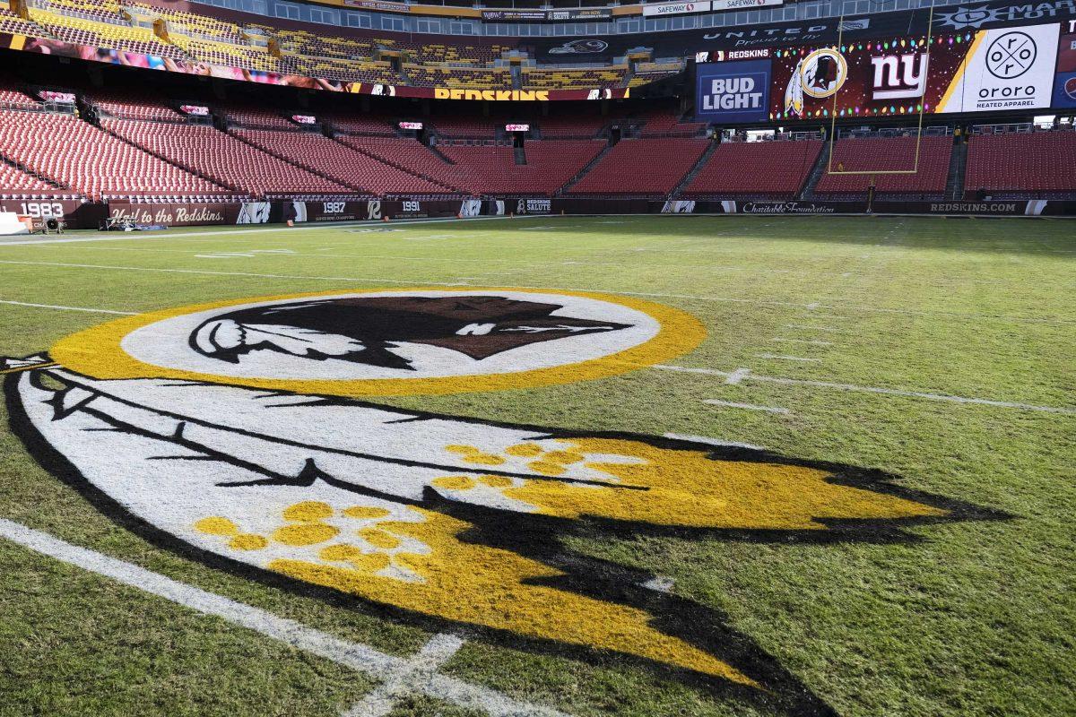 FILE - In this Dec. 22, 2019, file photo, the Washington Redskins logo is seen on FedEx Field prior to an NFL football game between the New York Giants and the Redskins in Landover, Md. Washington state Attorney General Bob Ferguson says Seattle-based Amazon will begin pulling Redskins team merchandise from its online marketplace. Ferguson urged the online giant to remove such merchandise it because of growing calls for the team to change what he called their use of a racial slur in the name. (AP Photo/Mark Tenally, File)