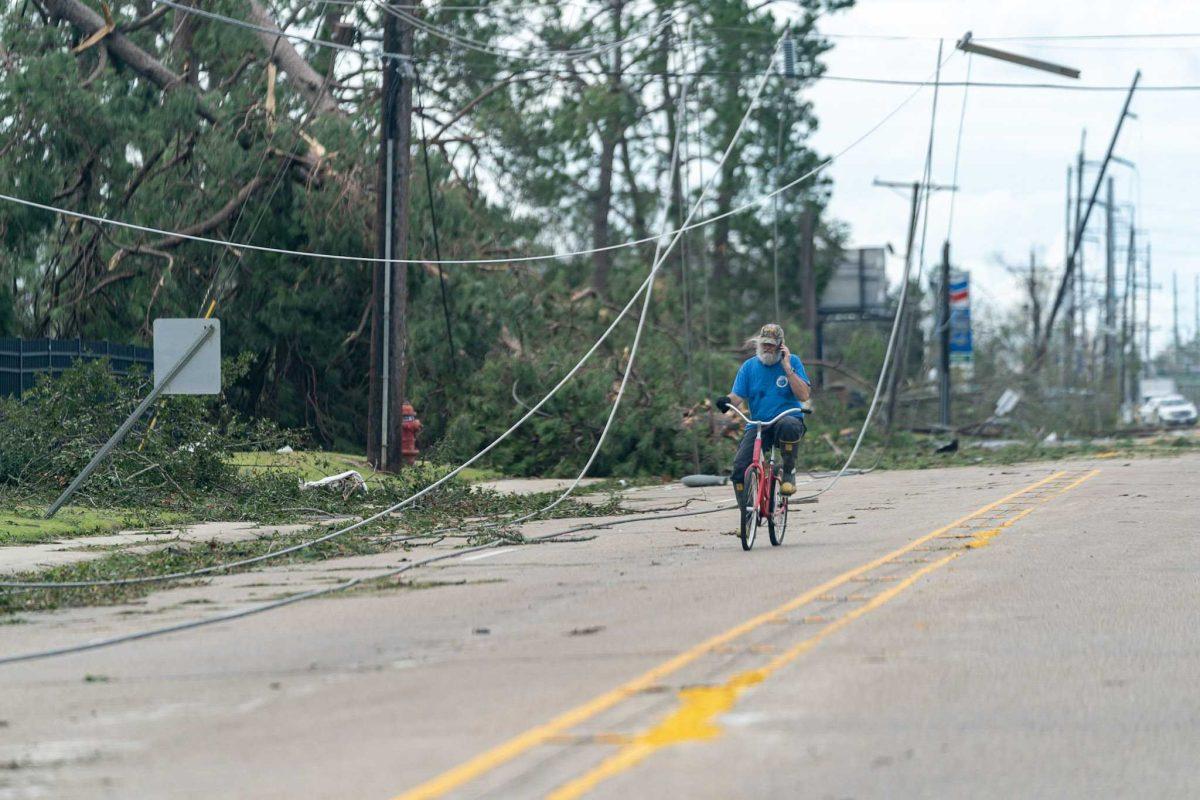 A man rides his bicycle through Lake Charles, LA, on Thursday, Aug. 27, 2020, after Hurricane Laura swept through the area the night before.