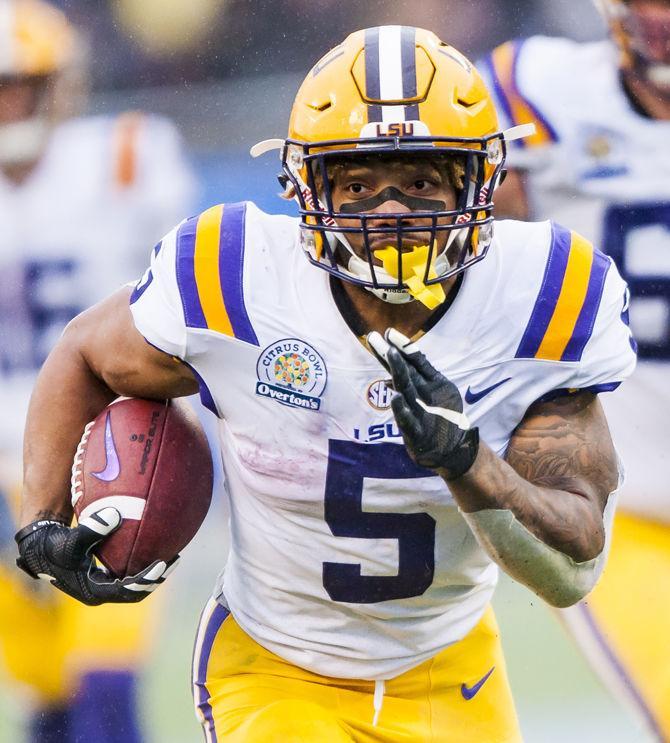 LSU junior running back Derrius Guice (5) runs the ball in for a touchdown during the Tigers' 17-21 loss to Notre Dame in the Citrus Bowl on Monday, Jan. 1, 2018 in Camping World Stadium in Orlando, Florida.