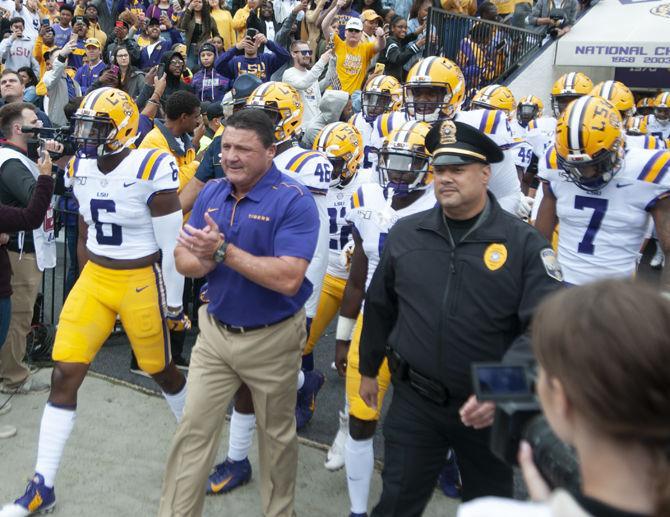 LSU football coach Ed Orgeron and his players walk on the field before the Tigers' game against Auburn on Saturday, Oct. 26, 2019, at Tiger Stadium.