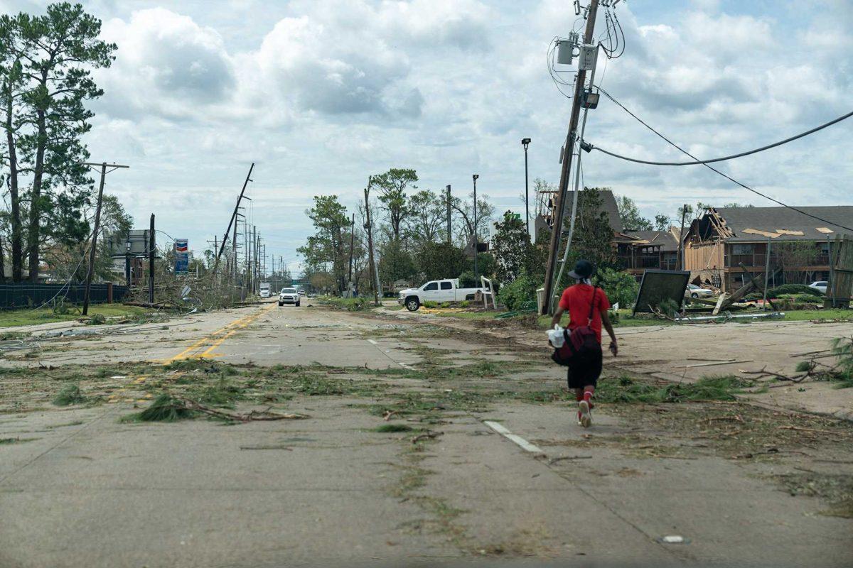 A man walks through Lake Charles, LA, on Thursday, Aug. 27, 2020, after Hurricane Laura swept through the area the night before.