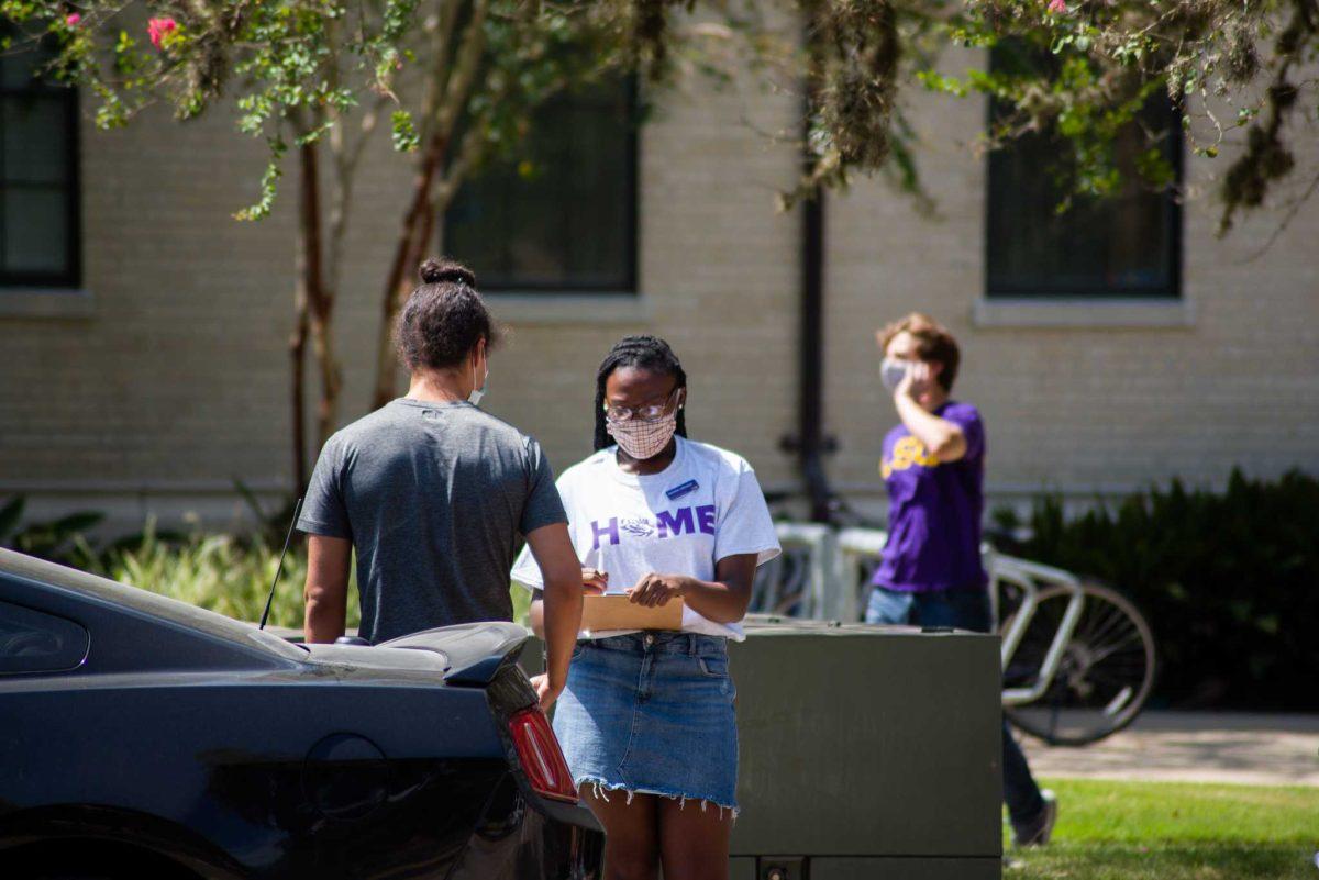 Move-in staff checks in an incoming student on Monday, Aug. 17, 2020 in front of East Laville Hall on South Campus Dr.&#160;